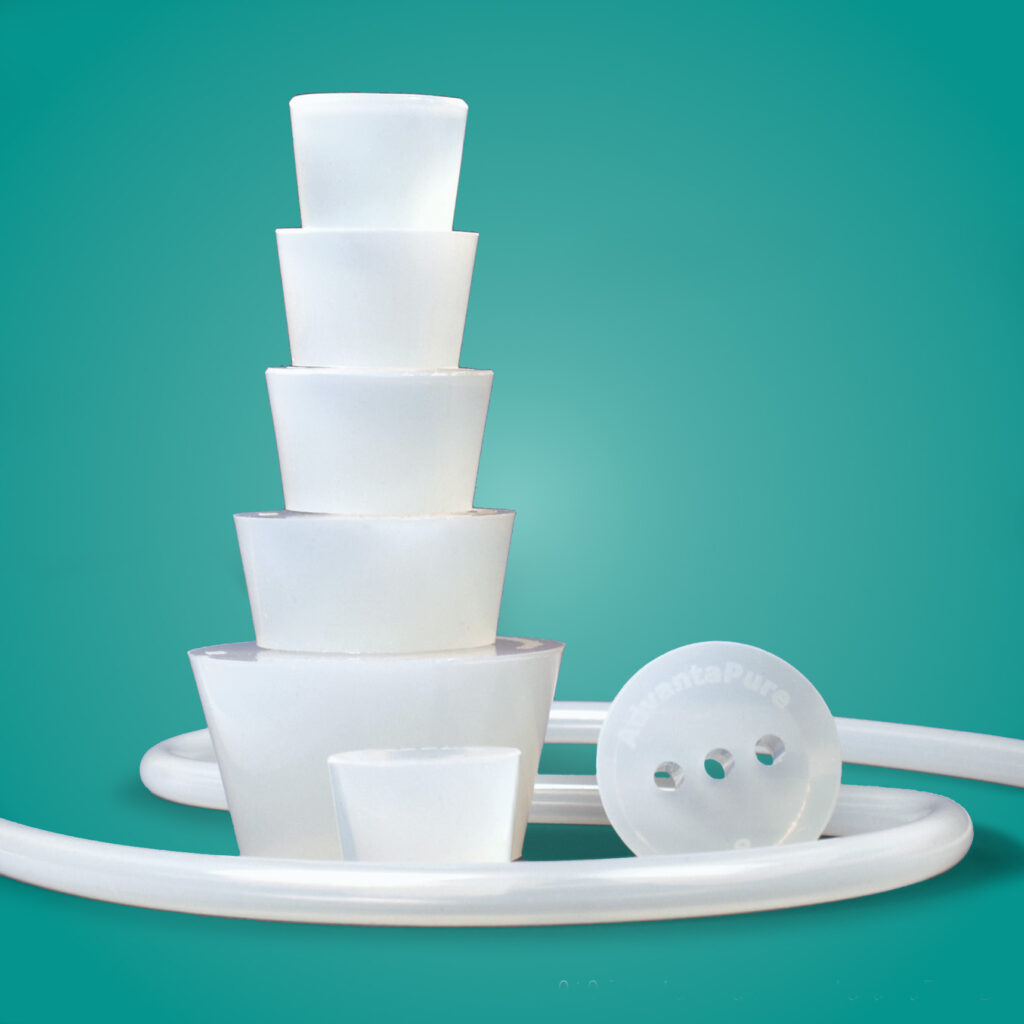 BioClosure bottle stoppers stacked on top of one another in on a teal background